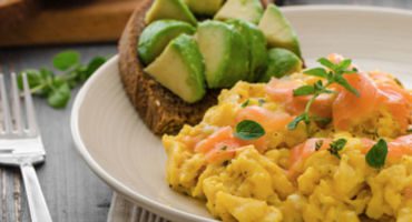 Scrambled eggs with avocado and salmon