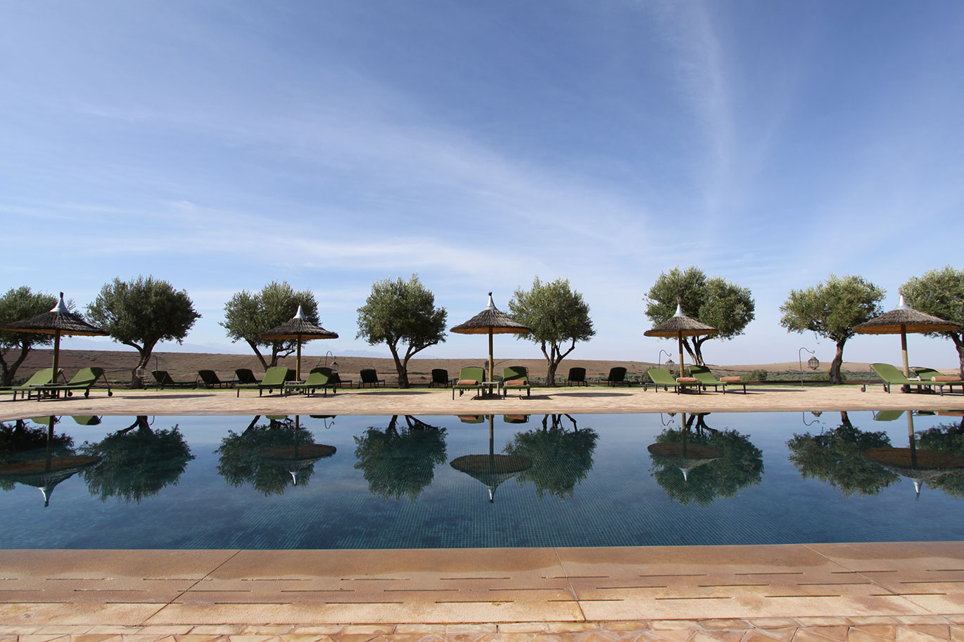 Pool in Marrakech with loungers and trees