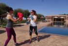 Two women personal training by the pool